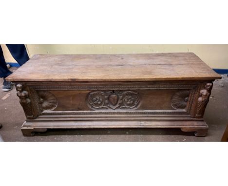 17TH CENTURY WALNUT CASSONE WITH CARVED CENTRAL PANEL FLANKED BY CARYATID FIGURES WITH IRONWORK CARRYING HANDLES 57CM H X 162