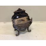 A brass mounted cast iron serpentine fire grate, width 46cm, depth 26cm, height 63cm