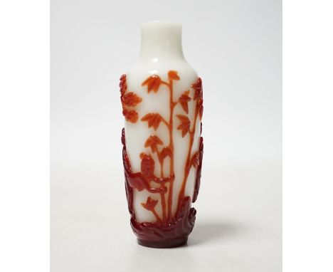 A Chinese ruby and white opaque glass erotic snuff bottle, early 20th century, 8cm high