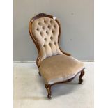 A Victorian walnut spoon back nursing chair, height 92cm