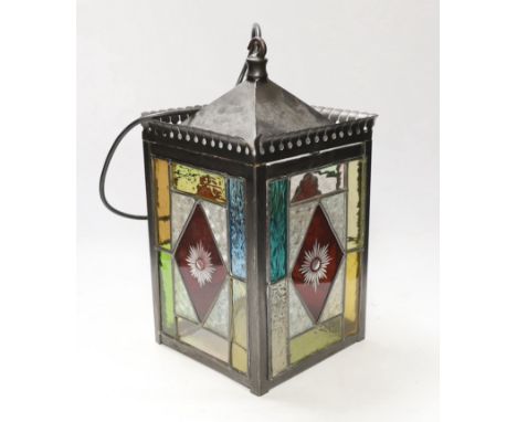 A stained glass panelled hanging lantern One vertical glass pane glue-repaired; one side solder-repaired top right, and loose