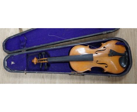 A wooden cased early 20th century Czechoslovakian student’s violin, bears ‘Copy of Stradivarius’ label, body length, 35.5cm, 