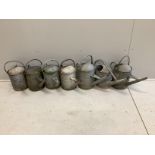 Seven vintage galvanised metal watering cans, largest height 43cm