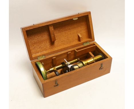 A brass monocular student’s microscope in fitted teak case, case 22cm