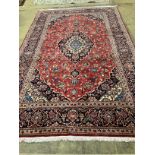 A Kashan red ground carpet, 308 x 190cm