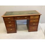 A late Victorian mahogany kneehole writing table, fitted nine small drawers, width 130cm, depth