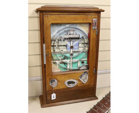 A 1950s Wondermatics Allwin penny slot machine, 'Win and Place' pin ball machine in oak case, 79 x 50cmMechanism working inte