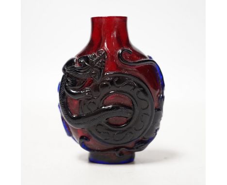 A Chinese amethyst and ruby glass ‘dragon’ snuff bottle, 19th century, 6cm high No damage seen; cover lacking.