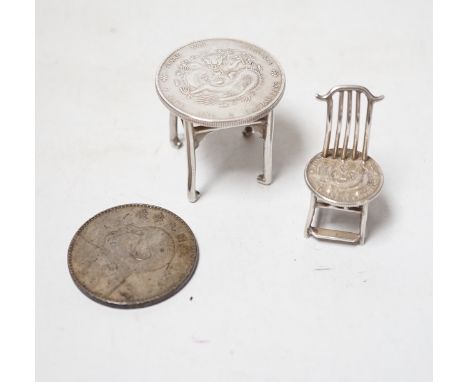 A Chinese Republic period one dollar 1920, and two Chinese Guangxu period coins mounted as miniature furniture,table 4vm high