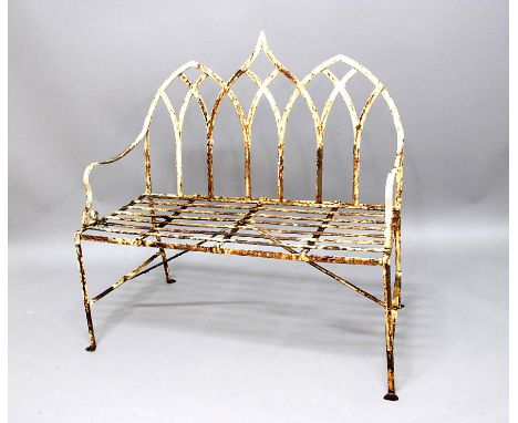 REGENCY STYLE IRON BENCH,  with triple arched back, scrolling arms and slatted seat, height 117cm