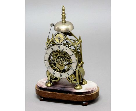 BRASS SKELETON CLOCK, the 5" silvered chapter ring beneath a strike silent dial, on a brass, architectural eight day chain dr