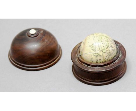 MINIATURE GLOBE, early 19th century, with paper gores, in a walnut case, diameter 4.3cm