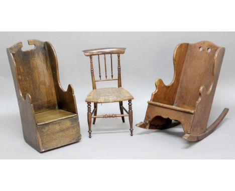 CHILD'S OAK ROCKING COMMODE CHAIR, with pierced handle, height 63cm; together with another, similar, but painted and a child'