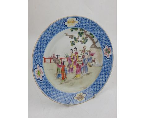 A late 19th/early 20th century Chinese enamel and underglaze blue plate, decorated with figures at leisure in a garden, six c