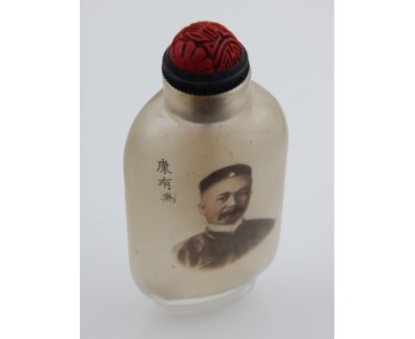 A Chinese glass snuff bottle, decorated with head and shoulder portrait of gentleman to one side and Chinese script to other.