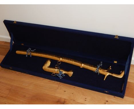 An Omani ceremonial sword with gilt scabbard, together with a jambiya, within a presentation case, (2)