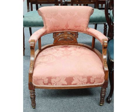 A Victorian Marquetry-Inlaid Rosewood Armchair, upholstered in pink satin, on ring-turned supports and moving on castors