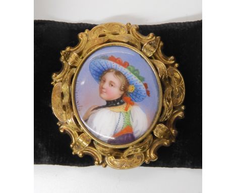 A BROOCH WITH ENAMEL PLAQUE SIGNED UNDERWALDthe hand painted enamel plaque of a maiden is set into a yellow metal brooch moun