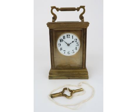 A FRENCH GILT BRASS CHIMING CARRIAGE CLOCK the white dial with Arabic numerals, 14cm high Condition Report: Has key, winds, b