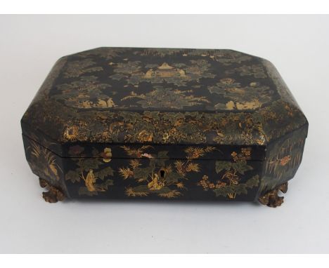 A CANTONESE BLACK AND GOLD LAQUERED SEWING BOX painted in gilts with immortals and figures beneath foliage, the hinged lid en