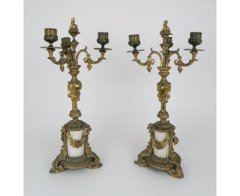 A PAIR OF GILT METAL AND ALABASTER CANDELABRA each with three branches and central floral finial, 45cm high Condition Report: