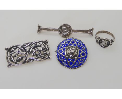 TWO ALEXANDER RITCHIE BROOCHES a round shield shape with blue enamel, has cast in AR IONA mark and further stamped A.R.ICA IO
