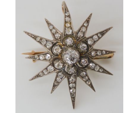 A VICTORIAN DIAMOND STAR BROOCH set with estimated approx 0.60cts of old cut diamonds, with further rose cut diamonds to the 