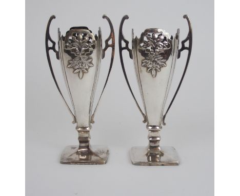 A PAIR OF CHINESE SILVER TWO HANDLED VASES decorated with pierced and chased foliage, stamped marks, 525 grams combined, 21.5