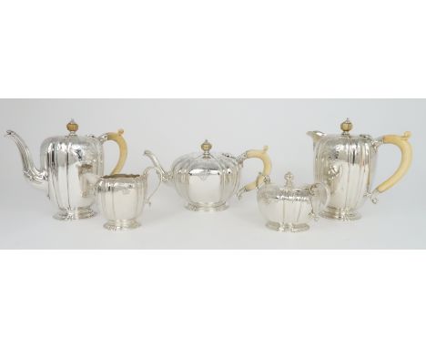 A FIVE PIECE SILVER TEA &amp; COFFEE SERVICE by the Goldsmiths &amp; Silversmiths Co. Ltd, London 1939 of tapering cylindrica