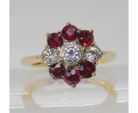 AN 18CT GOLD RUBY AND DIAMOND CLUSTER RING set with estimated approx 0.50cts of brilliant cut diamonds. Head of the ring size