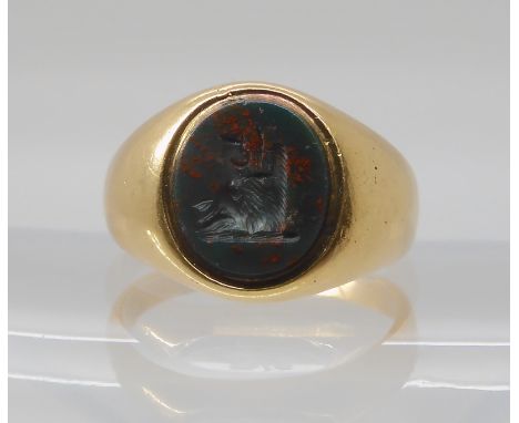 AN 18CT GOLD BLOODSTONE SIGNET RING with an intaglio bloodstone carved with a heraldic boar's head. Size S, weight 9.8gms  Co