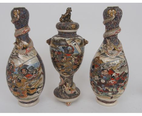 A SATSUMA GARNITURE OF THREE VASES painted with Scholars and Samurai, the vases with coiled dragons tye central vase and cove