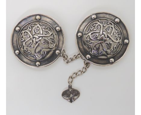 AN UNUSUAL ALEXANDER RITCHIE SILVER CLOAK CLASP of round shield shape with the bosses formed of leafy branches forming a celt