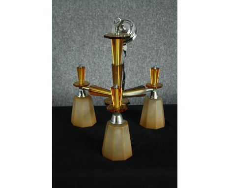 A 1930s Art Deco chandelier. Chromed metal with orange glass surrounds and three branches of lights with glass shades. H.47 W
