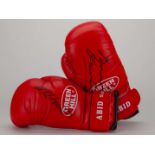 A pair of red boxing autographed boxing gloves