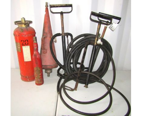 Three stirrup pumps and three vintage fire extinguishers. 