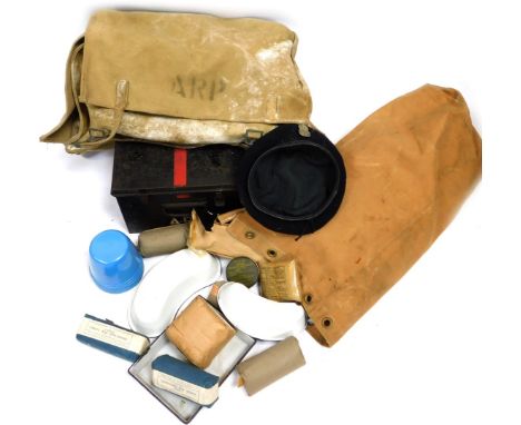 A World War II ARP medical satchel, first aid tin, and associated equipment.