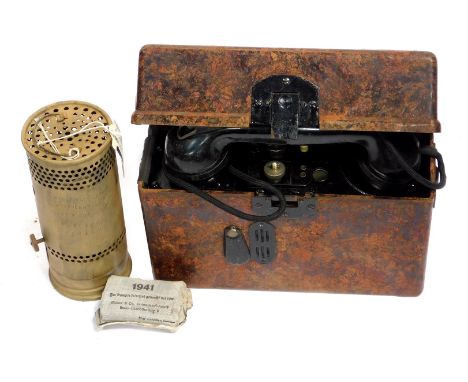A World War II German field telephone, first aid pack, and associated vehicle heater. 