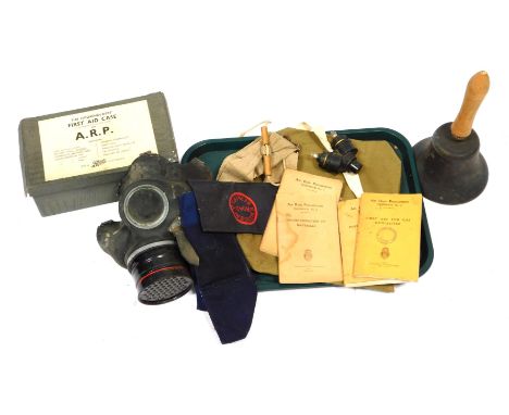 A selection of World War II Home Front items, to include gas mask, fire guard arm bands, ARP first aid case, etc. 