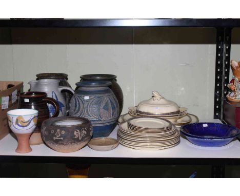 Shelf of stoneware planters and jugs, ceramic plates and tureen.