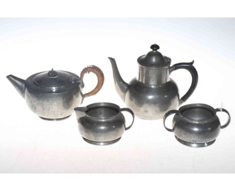 Liberty &amp; Co. Tudric pewter three piece tea set, and a pewter teapot (4).