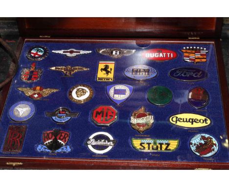 A cased collection of enamel badges of the World's Great Motor Cars.