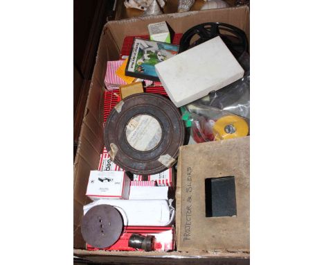 Box with vintage projector, slides and film reels.