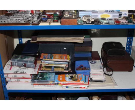 Shelf of books, postcards, stamps, covers, Ordnance Survey maps, binoculars, leather case.