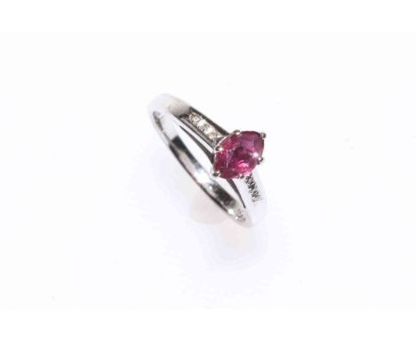 18k white gold oval ruby ring with diamond set shoulders, size K.