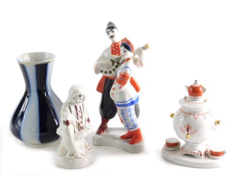 Three various 20thC Ukrainian figure groups to include Eskimo 13cm high, candle snuffer, a Ukrainian vase, USSR urn figure gr