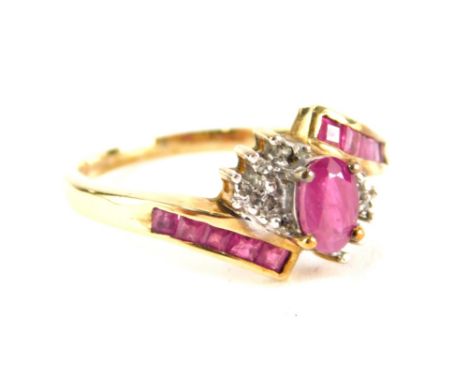 A 9ct gold cross over dress ring, set with pink and white claw set stones. 