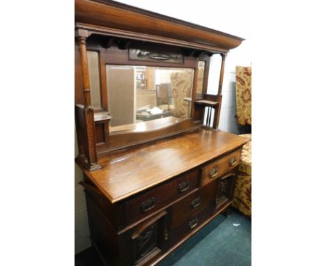 A late 19thC oak Art Nouveau mirror back sideboard, with canopy top inset with a copper panel, above a shaped glass flanked b
