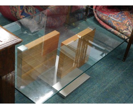 A retro teak metal and glass coffee table, of rectangular form, with a stepped centre section, 40cm high, 120cm wide, 77cm de