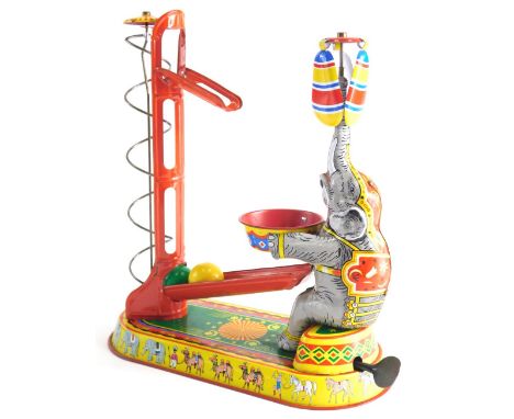 A 20thC tin plate clockwork elephant and ball automaton, 26cm high. 